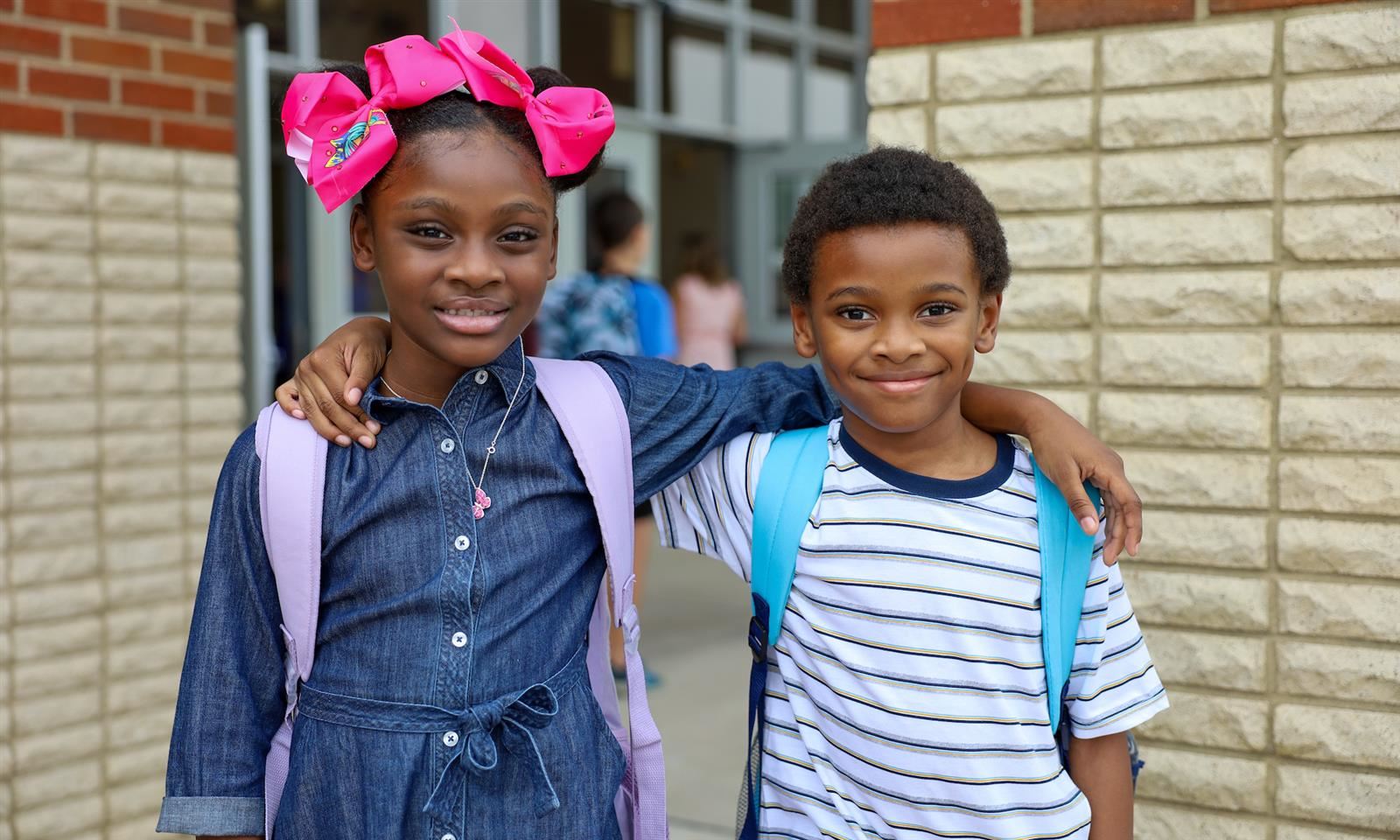 Two students smile on the first day of school